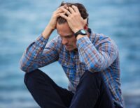 Person sitting outdoors practicing mindfulness to reduce worry and anxiety